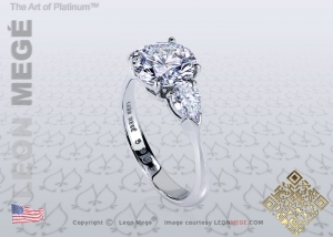 Three stone engagement ring with a round diamond and pear shape side stones by Leon Megé