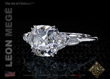 Five stone engagement ring featuring an antique cushion cut diamond by Leon Mege.
